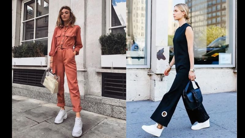 Cô gái mặc jumpsuit màu be và giày thể thao trắng